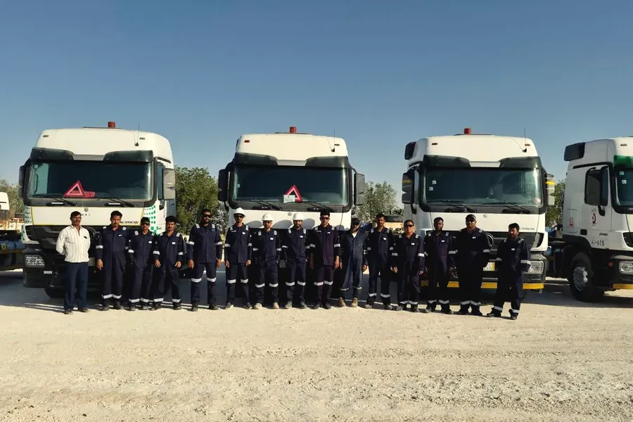 Ajyal winch trucks lined up in the yard with their crews