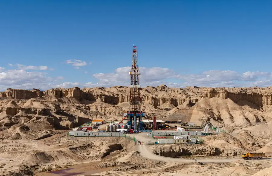 Land drilling rig standing among barren desert rock formations