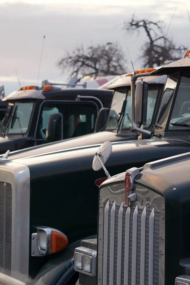 Kenworth bonneted heavy tractors drawn up in a yard