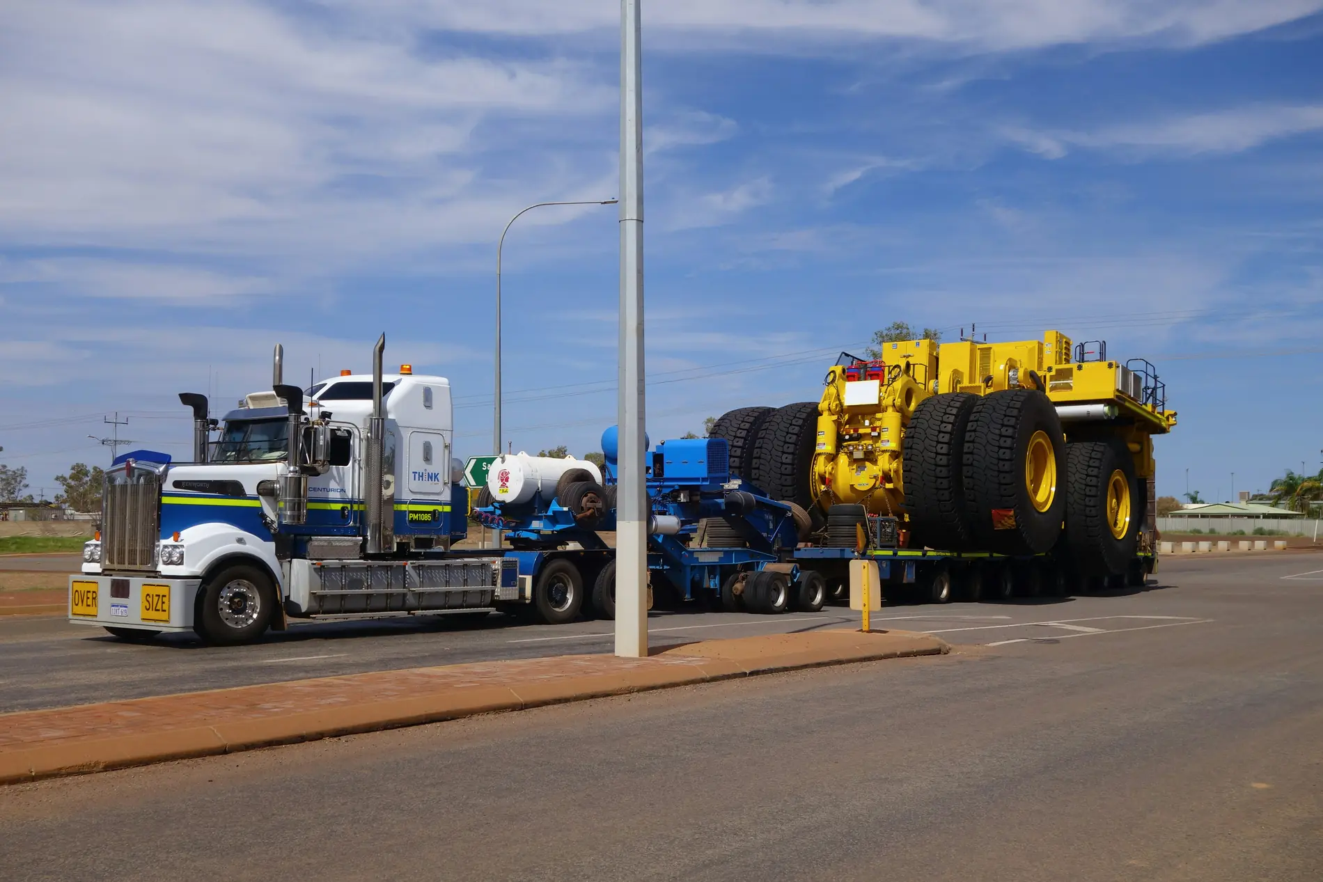 Prime mover hauling an oversize mining truck on a multi-axle lowbed