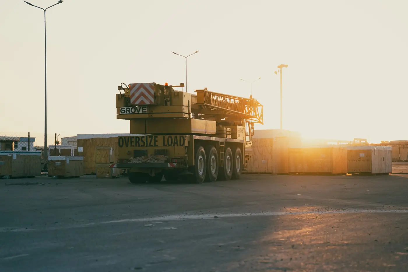 All-terrain mobile crane in a yard at golden hour