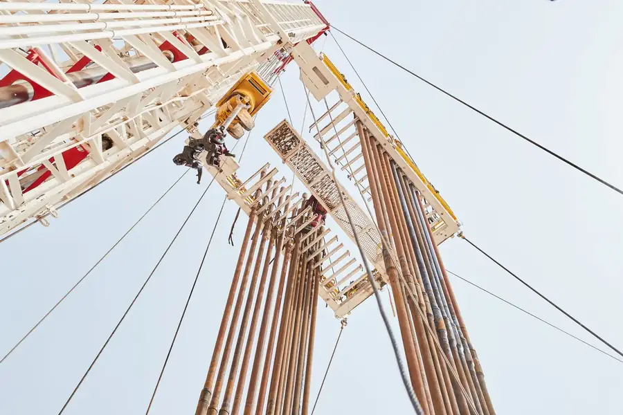 Mast and lifting works seen from below against the sky